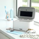 Fysic FC-35 reiniger in gebruik op vensterbank met bril, mondkapje en sieraden Fysic FC-35 reiniger in gebruik op vensterbank met bril, mondkapje en sieraden